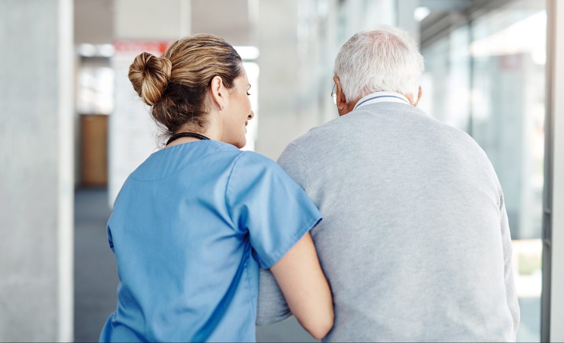 Making sure he gets his daily exercise Shot of a female nurse assisting her senior patient while walking
